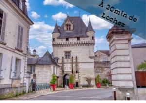 an old building with a tower with a castle at Appartement centre Descartes in Descartes