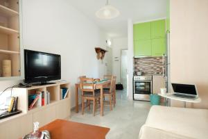 a small living room with a table and a kitchen at Apostolaki A. Apartment in Rethymno Town