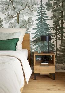a bedroom with a bed and a table with a lamp at MATT - Apartments ' Design-Apartment mit Balkon in Villingen-Schwenningen