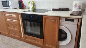 a kitchen with a sink and a washing machine at Iris Opera Center in Ruse