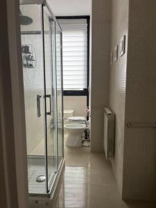 a bathroom with a glass shower and a toilet at LG RigeneraHouse in Mostacciano +15 photos