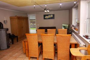 a dining room with a wooden table and chairs at Ferienhaus in Neukirchen nahe Sylt Strand in Neukirchen