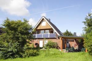 a house with solar panels on the roof at Ferienhaus in Neukirchen nahe Sylt Strand in Neukirchen