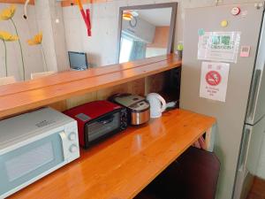 a counter with a microwave and a toaster oven on it at Guest House Terrace Sakashita - Vacation STAY 46671v in Naha +5 photos