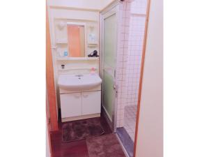 a bathroom with a sink and a mirror at Guest House Terrace Sakashita - Vacation STAY 46676v in Naha +6 photos