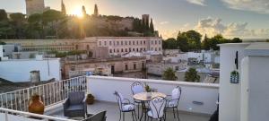 a balcony with a table and chairs overlooking a city at Casa vacanze Vista Castello in Oria