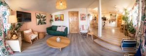 a living room with a green couch and a table at CASA TUCAN - BEACH JUNGLE PARADISE in Ensenada