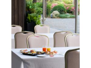 a table with a plate of food and glasses of orange juice at Sansuien - Vacation STAY 06800v in Kochi