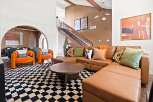 a living room with a couch and a table at Slide into Fun Pool Games Fire Pit Sport Court in Glendale +59 photos