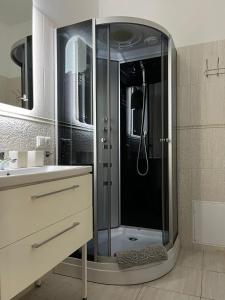 a bathroom with a shower with a glass door at Cozy Apartment in Old Riga & Free Underground Parking in Rīga +7 photos