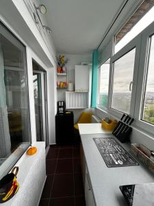 a room with a laptop on a counter with windows at Smile Studio in Suceava