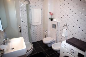 Un baño con lavabo, inodoro y ducha. en White Residence Luxury Apartments, en Sarandë 21 fotos más