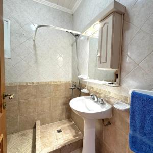 a bathroom with a sink and a mirror at Casa Roja in El Calafate
