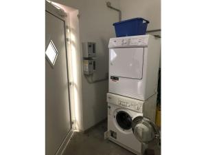 a laundry room with a washing machine and a washer at Verpust Comfortable holiday residence in Horumersiel +4 photos
