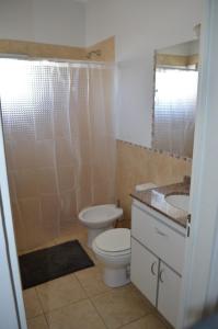 a bathroom with a toilet and a sink at Complejo Fátima in Villa Dolores