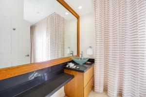 a bathroom with a sink and a mirror at Casa Victoria Orchid Hotel in Miami Beach +21 photos