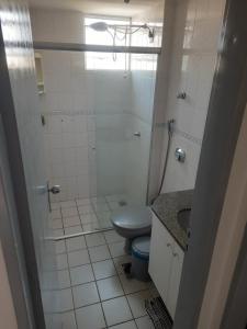 a white bathroom with a toilet and a shower at Residencial Thermas Rio Caldas 801 in Caldas Novas