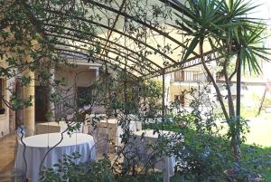 a room with two tables and some plants at Blao boutique hotel in Oristano +72 photos