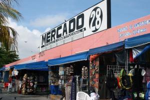 a store with a large sign on the side of a building at Mercado 28 Residences in Cancún