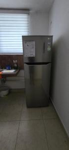 a stainless steel refrigerator in a room with a window at Mercado 28 Residences in Cancún