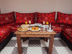 a table with plates of food on a couch at Dar Nourdha in Marrakesh