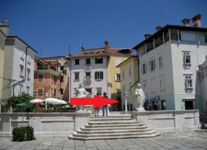 a group of people standing on stairs in a city at Top Line Apartments in Piran