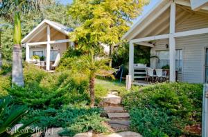 a backyard with a house and a patio at The White Chalet View in Moshav Ramot