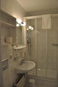 a bathroom with a sink and a shower at Hotel Kammerer in Sankt Georgen im Schwarzwald