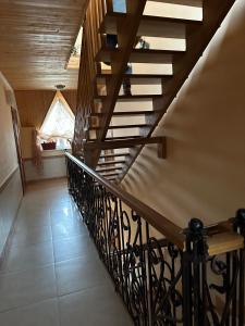 a spiral staircase in a house with a window at Вілла Львів in Skhidnitsa