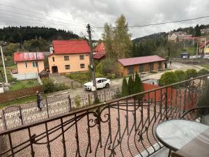 a white car parked on a street in a town at Вілла Львів in Skhidnitsa