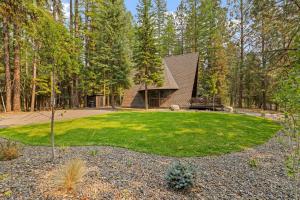 a large yard with a house in the woods at New! River Cabin A-Frame-Remodeled A-Frame on the river, walk to town, lake & dining in McCall