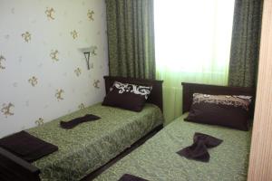 two beds in a room with shoes on them at Villa Katalina in Varna City