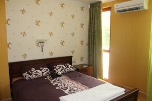 a bedroom with a bed and a window at Villa Katalina in Varna City
