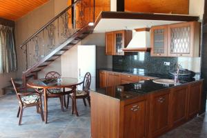 a kitchen with a table and a dining room at Villa Katalina in Varna City