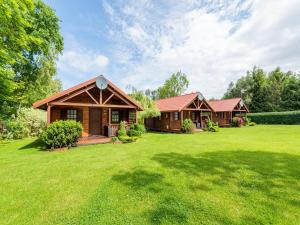 a home with a large yard with a house at Cottage in Ustronie Morskie near Aquapark in Ustronie Morskie
