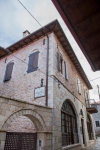 a building with a sign on the side of it at Kaza Guesthouse in Dimitsana