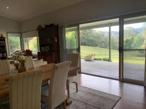 Grandmas Cottage Fairmont في Woodhill: غرفة طعام مع طاولة وكراسي ونافذة كبيرة