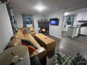 a living room with a couch and a fireplace at Wally's House in Hawley