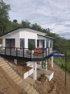 a house with people sitting on the deck of it at Esmeralda PLUS in San Gil +12 photos
