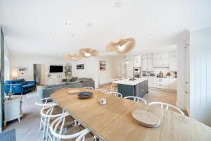 a kitchen and living room with a wooden table and chairs at Portsalon Cottage in Portsalon