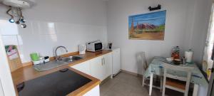 a small kitchen with a sink and a table at Anaga Playa Benijo 2 Paraíso Rural Trail-Beach in Almáciga +35 photos