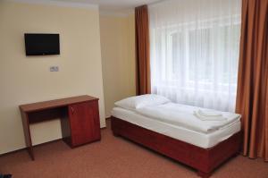 A bed or beds in a room at Hotel Rudka