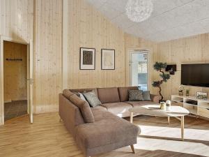 a living room with a couch and a table at 24 person holiday home in Frederiksværk in Frederiksværk
