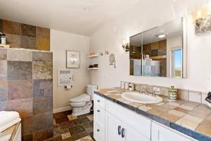 a bathroom with a sink and a toilet at Whispering Oaks Manor-Pets Ok, Spa, Game room in Paso Robles +57 photos