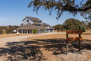 a house sitting on the side of a road at Whispering Oaks Manor-Pets Ok, Spa, Game room in Paso Robles