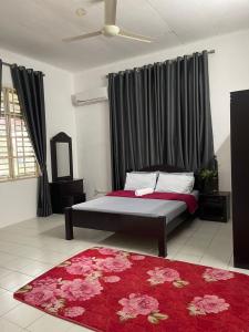 パリト・ブンターにあるHomestay MamaTwinz, musslimstay, Parit Buntarのベッドルーム1室(ベッド1台、赤いラグ付)
