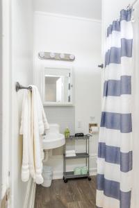a bathroom with a sink and a shower curtain at Solvang Bungalow B in Solvang +5 photos