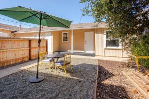 a patio with a table and chairs and an umbrella at Solvang Bungalow B in Solvang