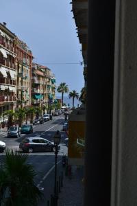 a view from a window of a city street with cars at Hotel Milanesina in Alassio