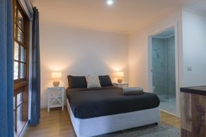 a bedroom with a bed and a walk in shower at Dartmouth Hotel Pub in Dartmouth